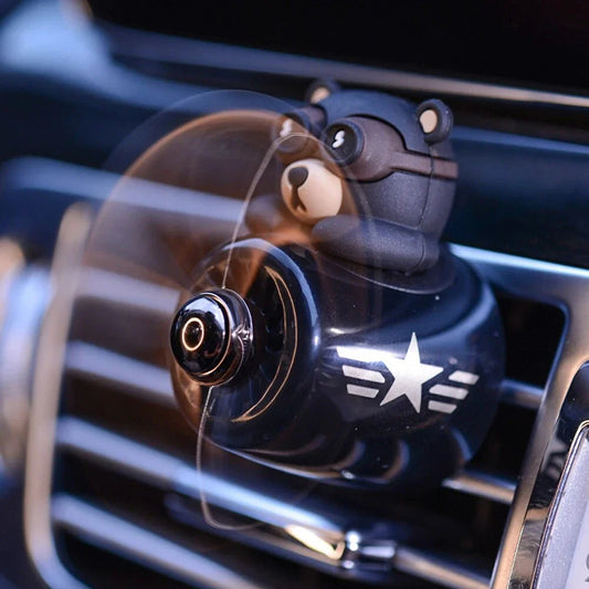 Bear Pilot Car Air Freshener with spinning propeller, diffusing a calming ocean fragrance in a vehicle