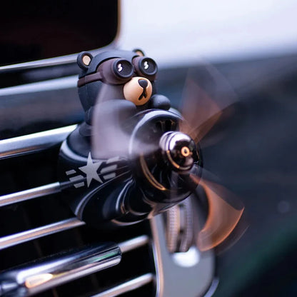 Bear Pilot Car Air Freshener with spinning propeller, diffusing a calming ocean fragrance in a vehicle