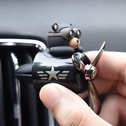 Bear Pilot Car Air Freshener with spinning propeller, diffusing a calming ocean fragrance in a vehicle