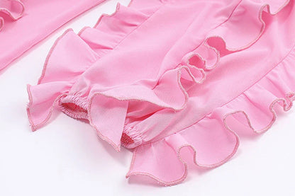 A girls' short top with a v-neck, ruffled trim, and a heart-shaped bow tie, made from stretchy chiffon fabric