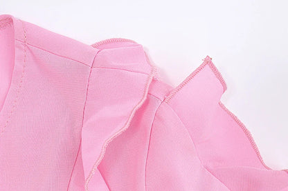 A girls' short top with a v-neck, ruffled trim, and a heart-shaped bow tie, made from stretchy chiffon fabric