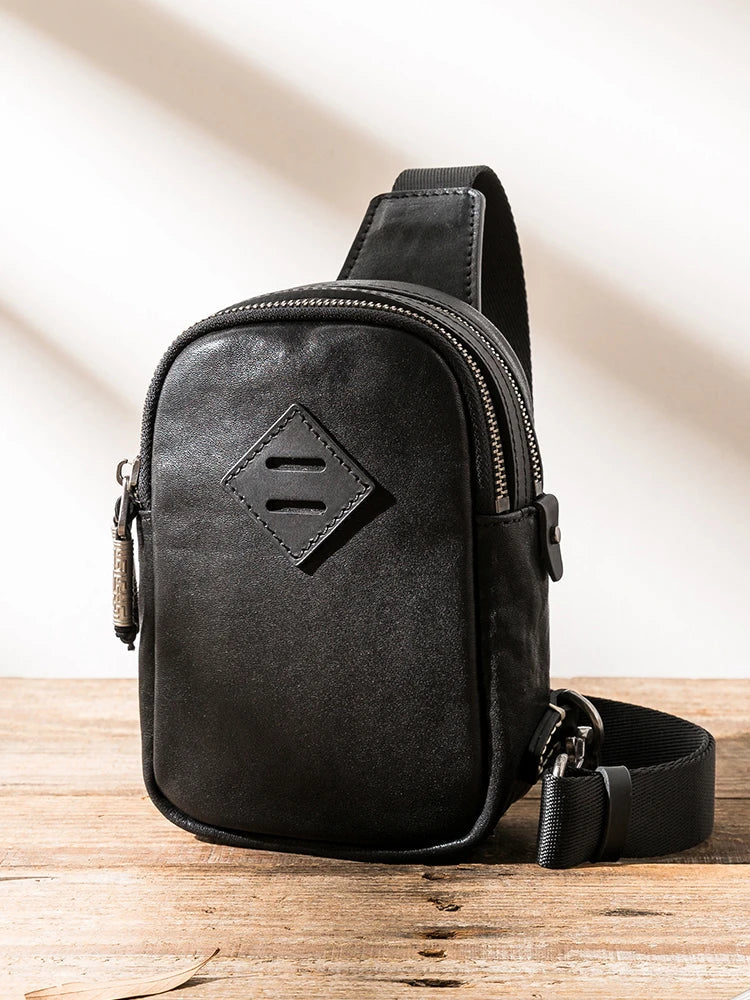 Stylish black leather chest bag with adjustable strap for modern urban gentlemen