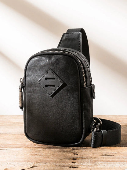 Stylish black leather chest bag with adjustable strap for modern urban gentlemen