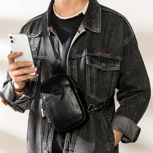 Stylish black leather chest bag with adjustable strap for modern urban gentlemen