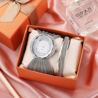 Elegant floral-patterned watch with a gold and silver mesh strap