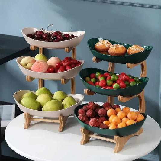 Partitioned oval table plates and fruit bowl with tiered candy and cake trays in beige