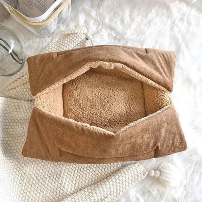 Cosy winter cat bed in plush brown fabric with a charming cartoon design, providing a warm and comfortable retreat for feline companions.