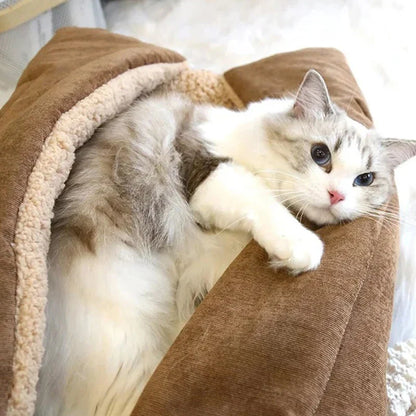 Cosy winter cat bed in plush brown fabric with a charming cartoon design, providing a warm and comfortable retreat for feline companions.