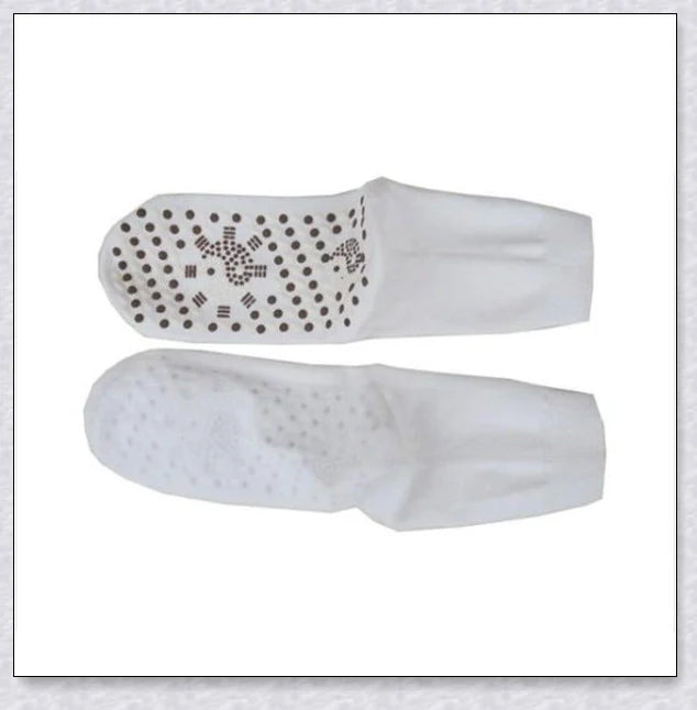 A pair of self-warming massage socks in black, red, and white colours