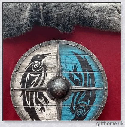 Authentic battle-worn Viking shield with two ravens design and iron spikes, adorned with Celtic buckle and rune characters