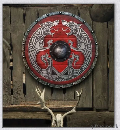 Authentic battle-worn Viking shield with two ravens design and iron spikes, adorned with Celtic buckle and rune characters
