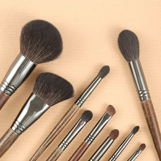 A set of 9 premium makeup brushes with soft goat hair bristles and natural wood handles, designed for flawless makeup application.