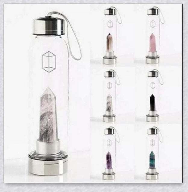 A natural crystal water bottle made of borosilicate glass, featuring a variety of healing crystals inside to enhance your hydration experience.