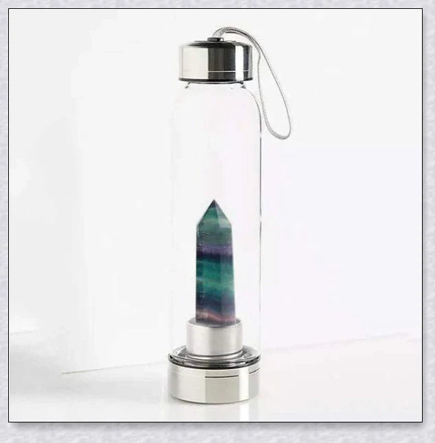 A natural crystal water bottle made of borosilicate glass, featuring a variety of healing crystals inside to enhance your hydration experience.