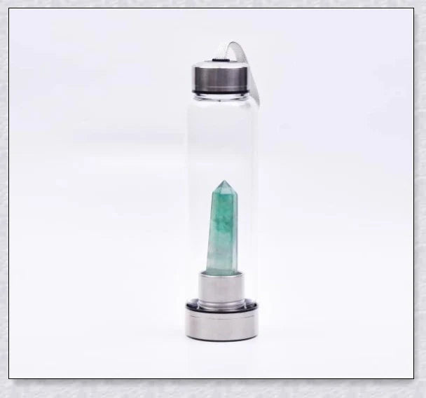 A natural crystal water bottle made of borosilicate glass, featuring a variety of healing crystals inside to enhance your hydration experience.