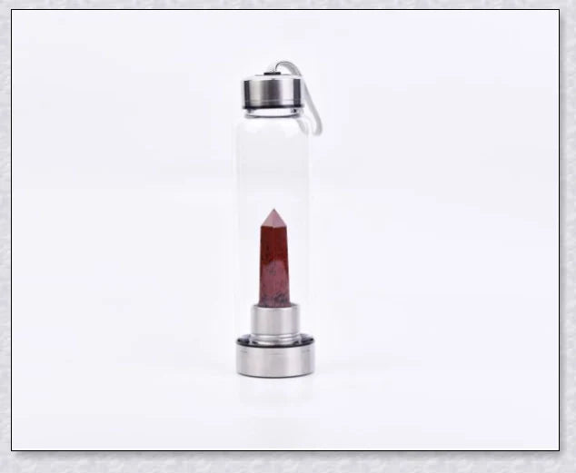 A natural crystal water bottle made of borosilicate glass, featuring a variety of healing crystals inside to enhance your hydration experience.