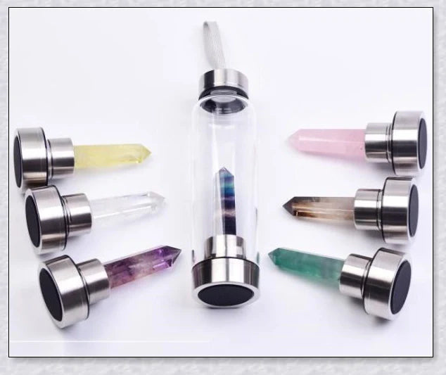 A natural crystal water bottle made of borosilicate glass, featuring a variety of healing crystals inside to enhance your hydration experience.