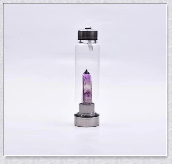A natural crystal water bottle made of borosilicate glass, featuring a variety of healing crystals inside to enhance your hydration experience.