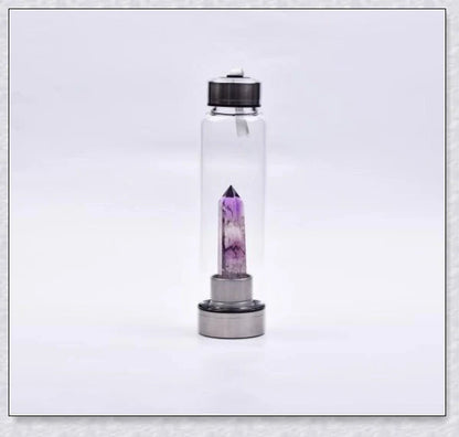 A natural crystal water bottle made of borosilicate glass, featuring a variety of healing crystals inside to enhance your hydration experience.