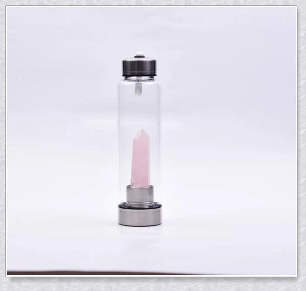 A natural crystal water bottle made of borosilicate glass, featuring a variety of healing crystals inside to enhance your hydration experience.