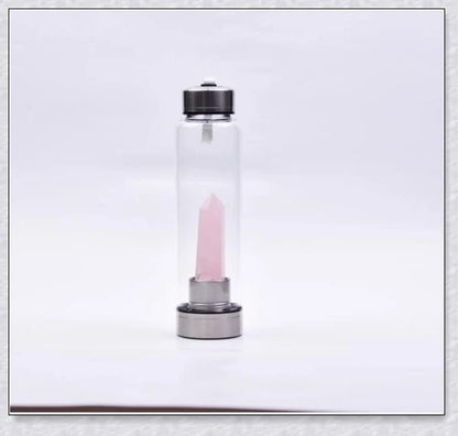 A natural crystal water bottle made of borosilicate glass, featuring a variety of healing crystals inside to enhance your hydration experience.