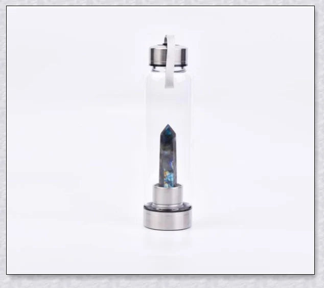 A natural crystal water bottle made of borosilicate glass, featuring a variety of healing crystals inside to enhance your hydration experience.