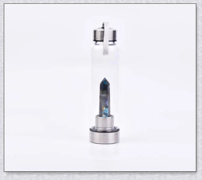 A natural crystal water bottle made of borosilicate glass, featuring a variety of healing crystals inside to enhance your hydration experience.