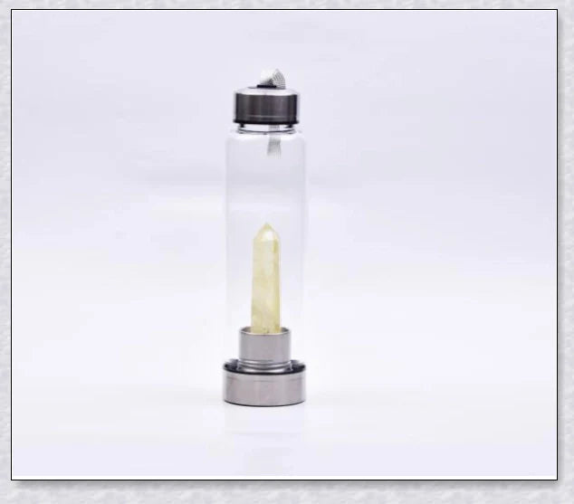 A natural crystal water bottle made of borosilicate glass, featuring a variety of healing crystals inside to enhance your hydration experience.