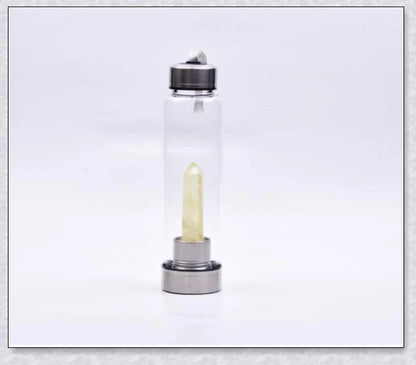 A natural crystal water bottle made of borosilicate glass, featuring a variety of healing crystals inside to enhance your hydration experience.