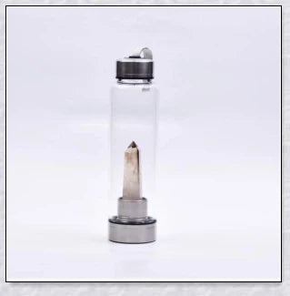A natural crystal water bottle made of borosilicate glass, featuring a variety of healing crystals inside to enhance your hydration experience.