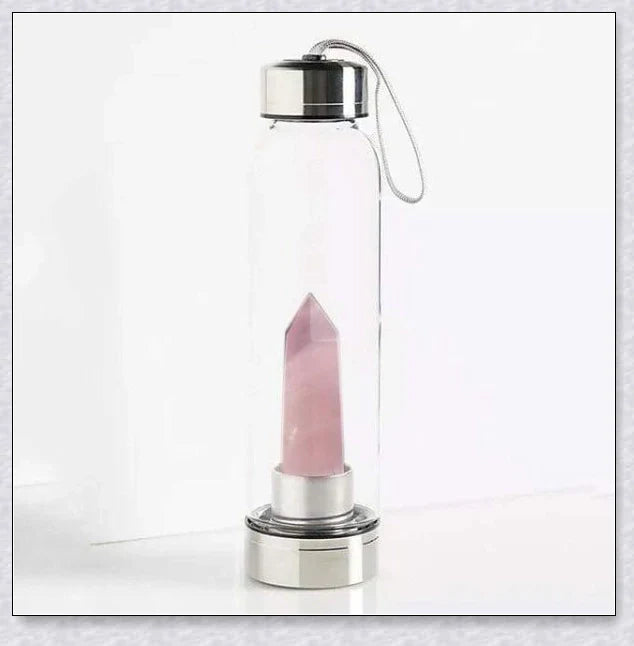 A natural crystal water bottle made of borosilicate glass, featuring a variety of healing crystals inside to enhance your hydration experience.