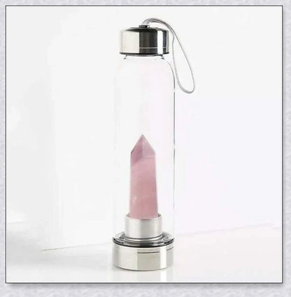 A natural crystal water bottle made of borosilicate glass, featuring a variety of healing crystals inside to enhance your hydration experience.