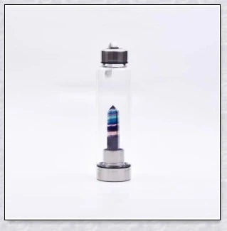 A natural crystal water bottle made of borosilicate glass, featuring a variety of healing crystals inside to enhance your hydration experience.