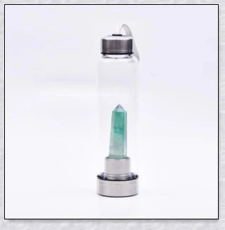 A natural crystal water bottle made of borosilicate glass, featuring a variety of healing crystals inside to enhance your hydration experience.