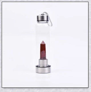 A natural crystal water bottle made of borosilicate glass, featuring a variety of healing crystals inside to enhance your hydration experience.