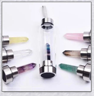 A natural crystal water bottle made of borosilicate glass, featuring a variety of healing crystals inside to enhance your hydration experience.
