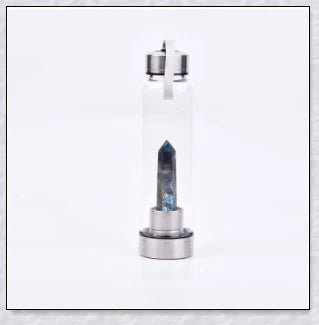 A natural crystal water bottle made of borosilicate glass, featuring a variety of healing crystals inside to enhance your hydration experience.