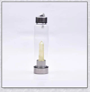 A natural crystal water bottle made of borosilicate glass, featuring a variety of healing crystals inside to enhance your hydration experience.