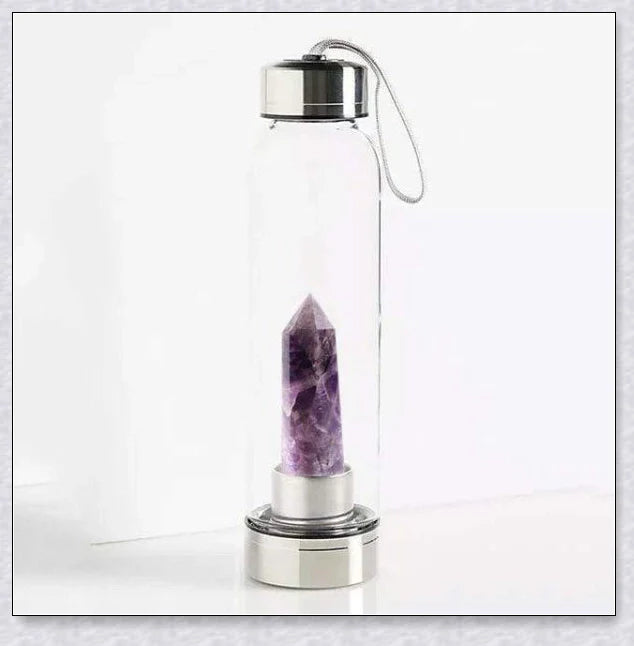 A natural crystal water bottle made of borosilicate glass, featuring a variety of healing crystals inside to enhance your hydration experience.