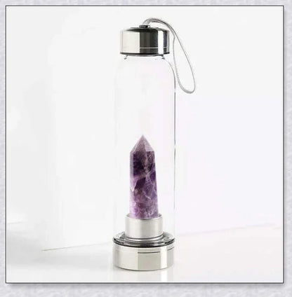 A natural crystal water bottle made of borosilicate glass, featuring a variety of healing crystals inside to enhance your hydration experience.
