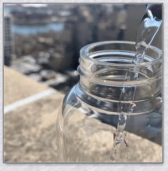 A natural crystal water bottle made of borosilicate glass, featuring a variety of healing crystals inside to enhance your hydration experience.