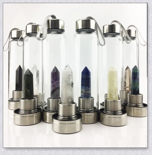 A natural crystal water bottle made of borosilicate glass, featuring a variety of healing crystals inside to enhance your hydration experience.