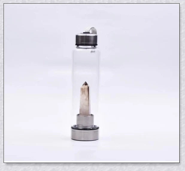 A natural crystal water bottle made of borosilicate glass, featuring a variety of healing crystals inside to enhance your hydration experience.
