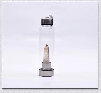 A natural crystal water bottle made of borosilicate glass, featuring a variety of healing crystals inside to enhance your hydration experience.