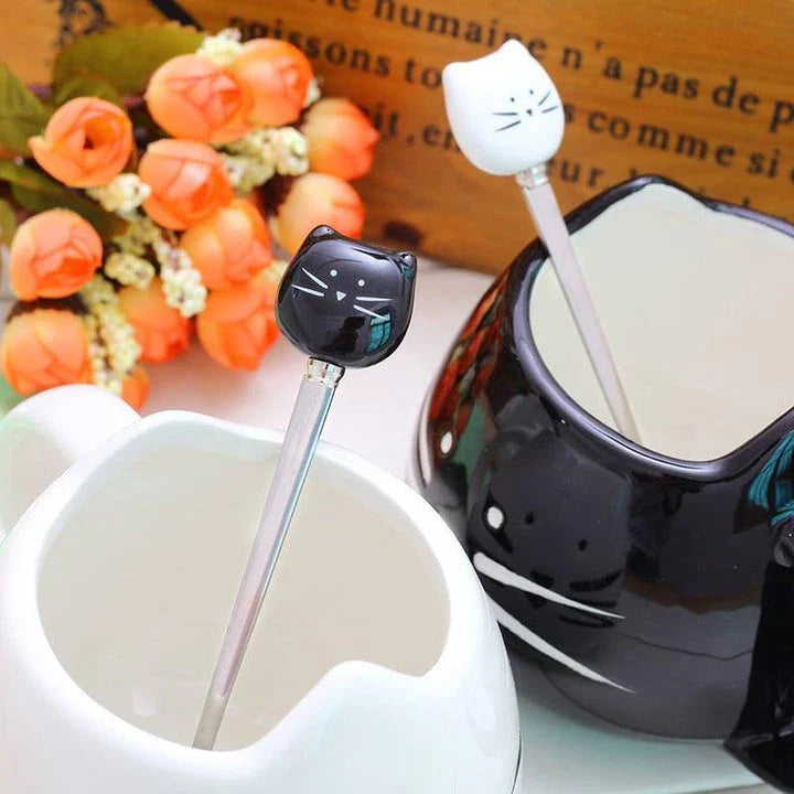 Cartoon cat-shaped ceramic coffee mug with matching stainless steel spoon, a practical and whimsical addition to any morning routine.