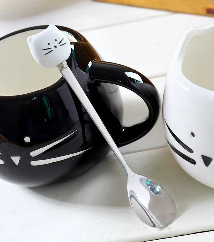 Cartoon cat-shaped ceramic coffee mug with matching stainless steel spoon, a practical and whimsical addition to any morning routine.