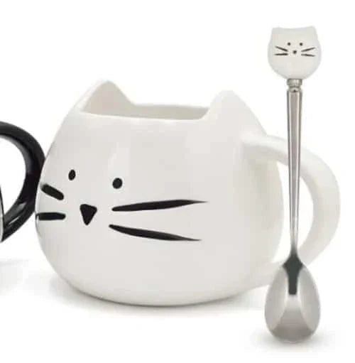 Cartoon cat-shaped ceramic coffee mug with matching stainless steel spoon, a practical and whimsical addition to any morning routine.