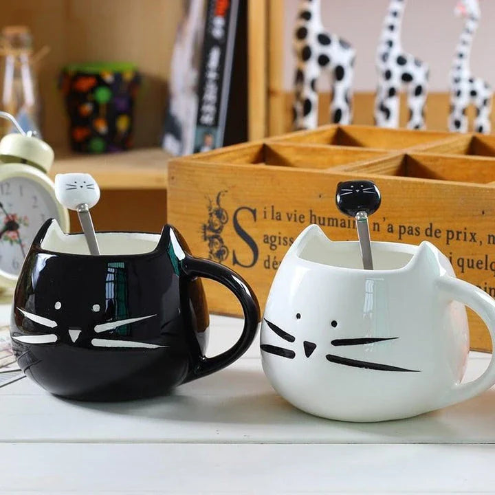 Cartoon cat-shaped ceramic coffee mug with matching stainless steel spoon, a practical and whimsical addition to any morning routine.