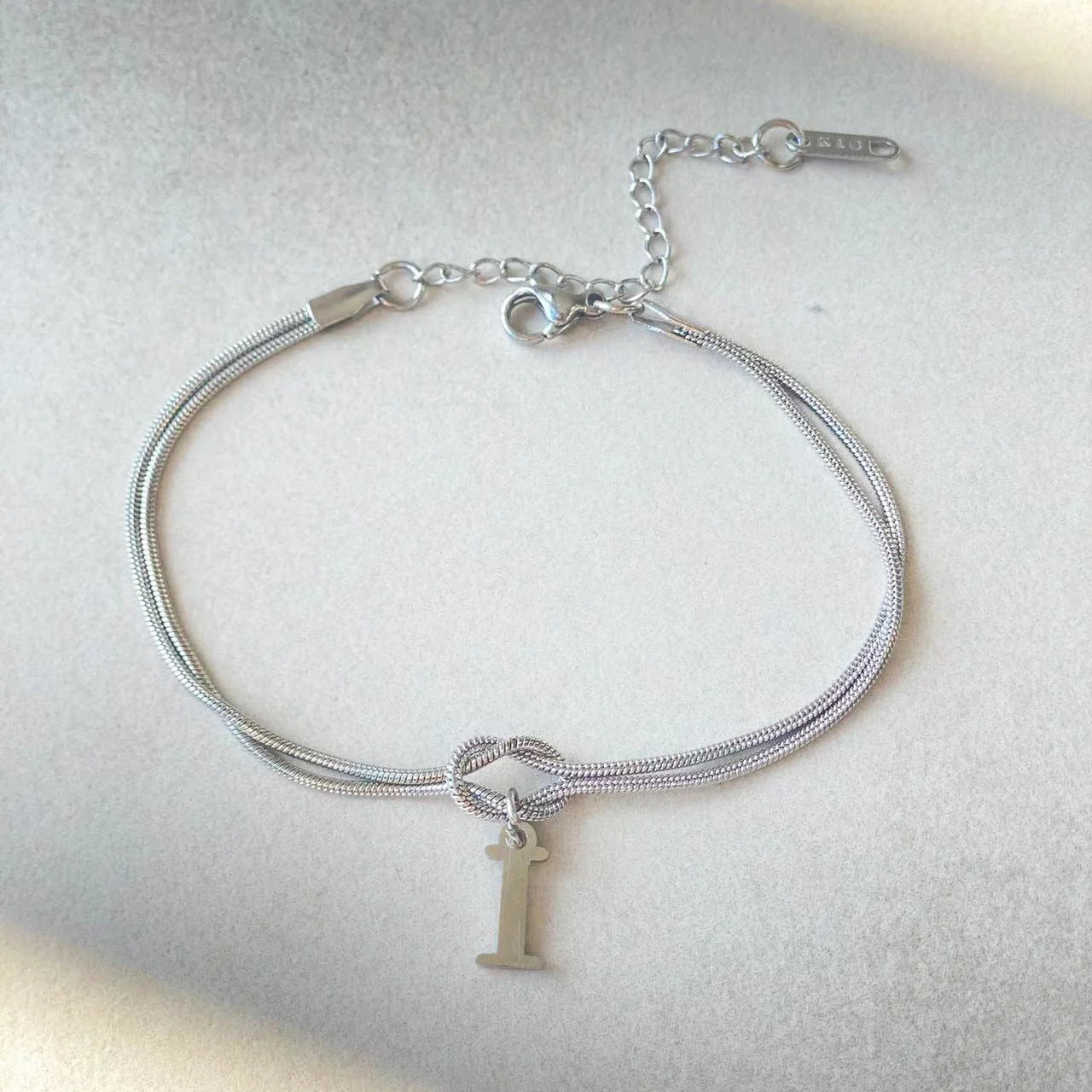 Personalised gold and silver love knot bracelets for couples, perfect as Valentine's Day gifts.