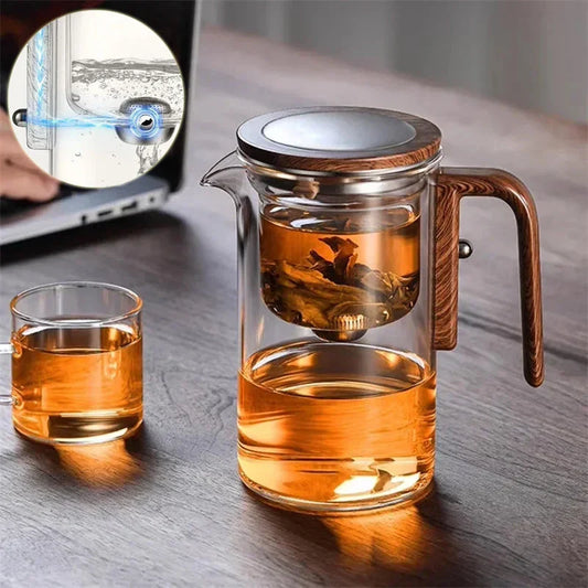 Smart one-button magnetic tea infuser pot with wooden handle, featuring heat-resistant borosilicate glass construction and seamless tea brewing experience.